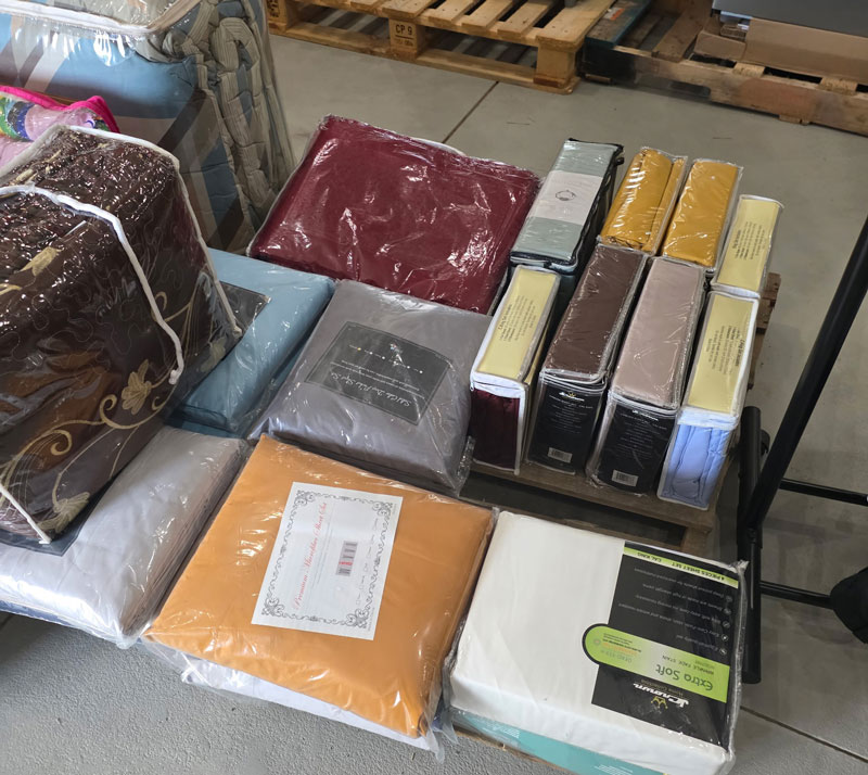 bedding comforters and sheets on a pallet